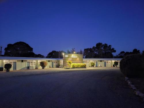 a building with a lit up sign on the side of it at Murray Bridge Motor Inn in Murray Bridge