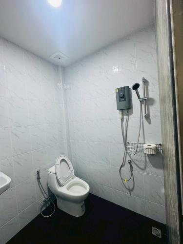 a bathroom with a toilet and a shower at Blue Mountain Kamala Phuket in Kamala Beach