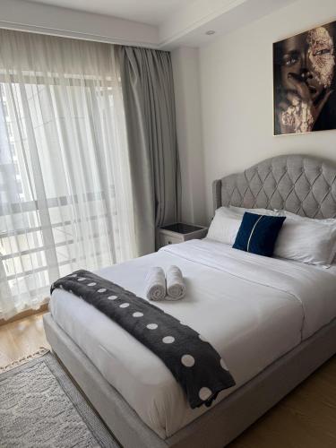 a bedroom with a large bed with two pillows on it at Zen Haven Lavington in Nairobi