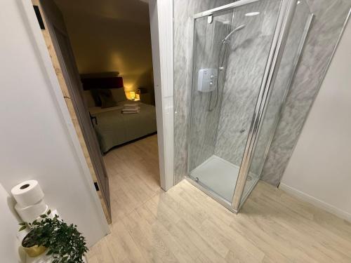 a shower with a glass door in a bathroom at Heartbeat Cottage By Travel Lets Holiday Homes Letterkenny With Private Ensuite Rooms & Garden in Letterkenny