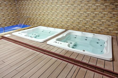a jacuzzi tub sitting on a wooden floor at Premium Wellness Institute in Bucharest
