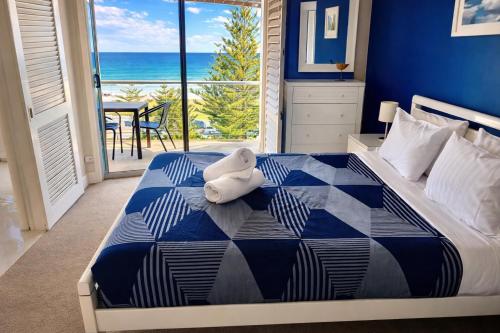 a bedroom with a bed with a teddy bear on it at The White Pearl Apartment Direct Ocean Views Top Floor in Perth