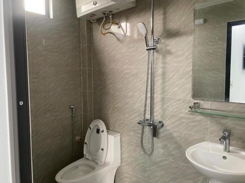 a bathroom with a shower and a toilet and a sink at Your Home in Vũ Lâm