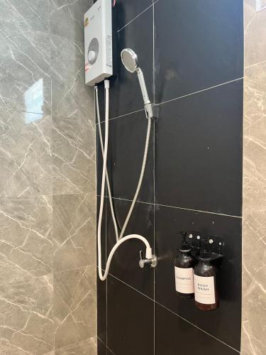 a shower in a bathroom with a shower head at เดย์ อิน in Ban Nong Sua Chang