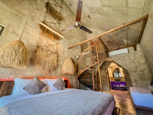 a bedroom with a bed with baskets on the wall at Diwatu Villas in El Nido