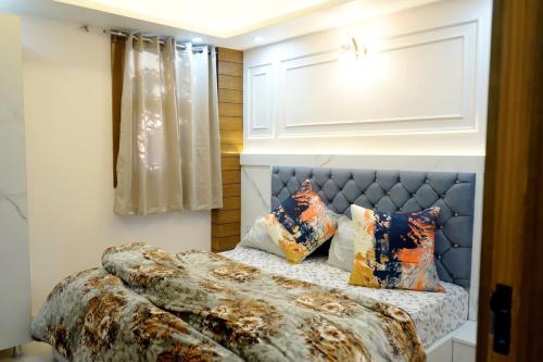 a bedroom with a bed with pillows on it at kailash keep in Haridwār