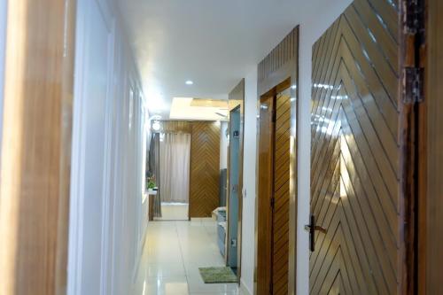 a hallway with a toilet and a door to a bathroom at kailash keep in Haridwār