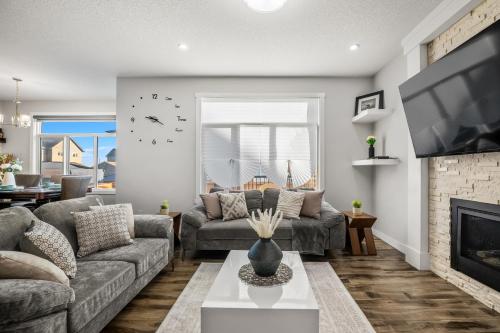 a living room with a couch and a fireplace at Luxury Retreat For Large Groups in Calgary
