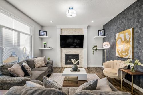 a living room with a couch and a fireplace at Luxury Retreat For Large Groups in Calgary