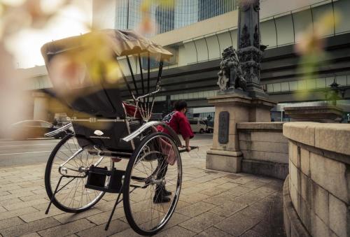 a bike parked on a sidewalk next to a statue at Mandarin Oriental, Tokyo in Tokyo