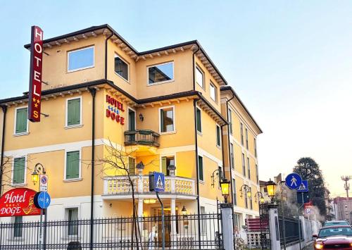 a yellow building with a sign in front of it at Hotel Doge in Vicenza