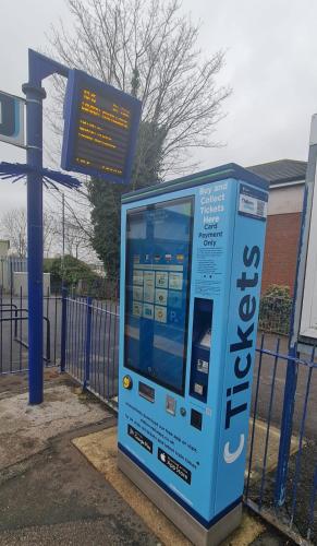 a blue donation machine in front of a gate at Bliss Home in Harrow on the Hill