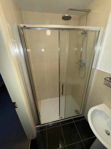 a glass shower in a bathroom with a sink at 4 Bedroom House By Travel Lets Holiday Homes Downings With Beautiful Ocean View in Downings