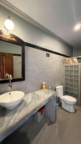 a bathroom with a sink and a toilet at Yoga bale house3 in Padangbai