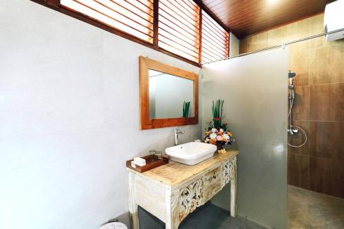 a bathroom with a sink and a mirror at Arsyana Villa in Sidemen