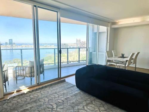 a bedroom with a bed and a view of the water at 114 Panoramic River Views 2BR High Floor & Parking in Perth