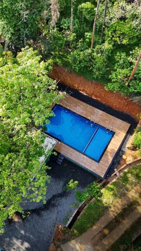 an overhead view of a swimming pool with a wooden deck at Bamboo Planet Resort in Vythiri