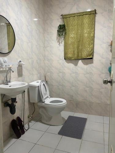 a bathroom with a toilet and a sink at Naybe's Room rentals in Dapa
