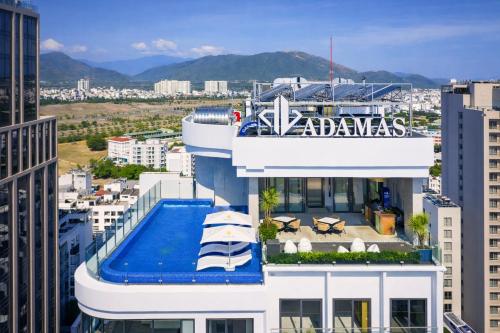a building with a swimming pool on top of it at Adamas Boutique Hotel Nha Trang in Nha Trang