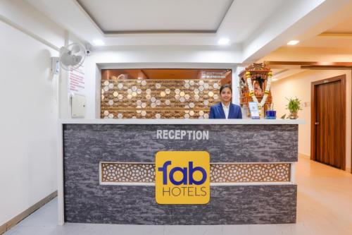 a man standing behind a reception counter at a hotel at FabHotel Arsh Executive Inn in Mumbai