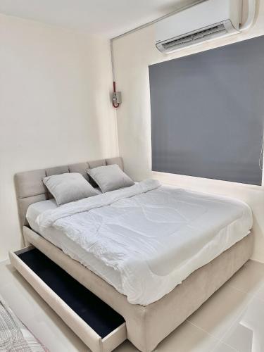 a bed in a white room with a projection screen at Casa Solara in General Santos
