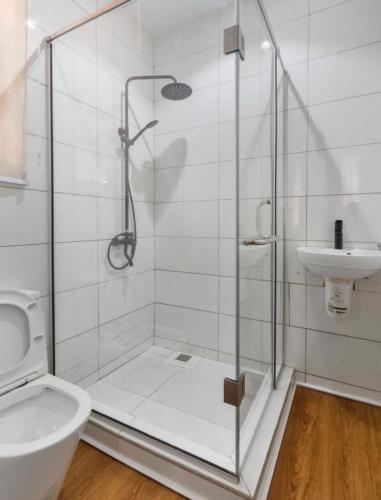 a bathroom with a shower and a toilet and a sink at Home helpers in Lagos