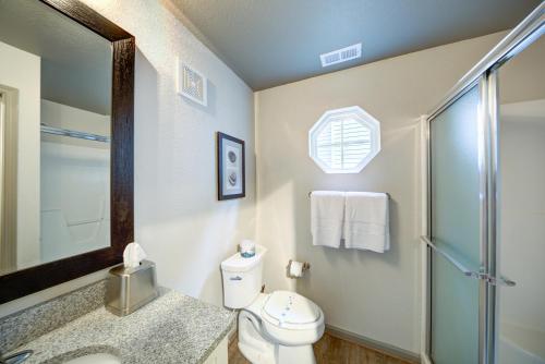 a bathroom with a toilet and a glass shower at Hilton Vacation Club Beachwoods Kitty Hawk in Kitty Hawk