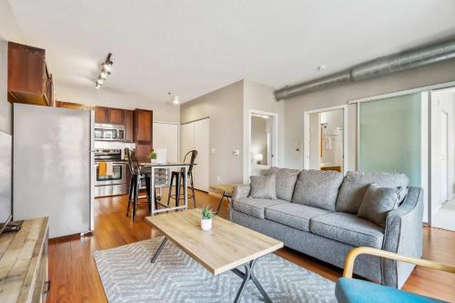 a living room with a couch and a table at CozySuites 2BR Mill District with pool, gym #04 in Minneapolis