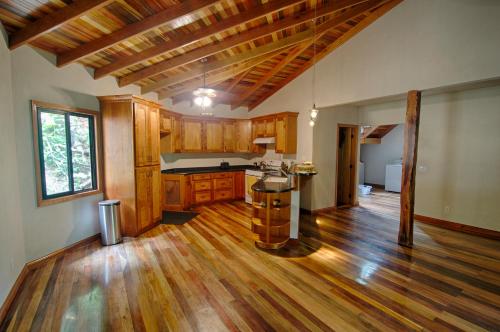 a large kitchen with wooden floors and a large window at Casa Santa Maria in Benque Viejo del Carmen