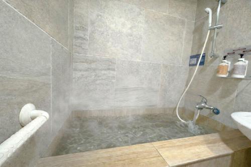 a bathroom with a bath tub with a sink at 東光行旅 in Xinyi