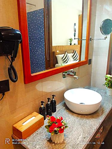 a bathroom with a sink and a mirror at Ella Green Cottages in Ella