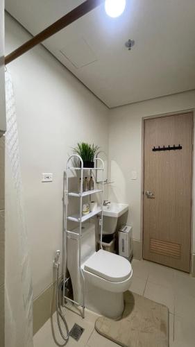 a bathroom with a toilet and a sink at Comfortable Studio Stay Made for Relaxation in Iloilo City