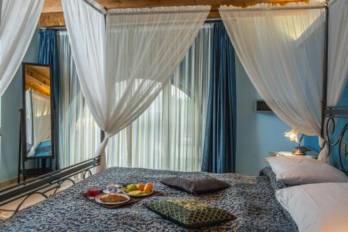 a bedroom with a bed with a tray of fruit on it at Agriturismo dei Grippi in Sona
