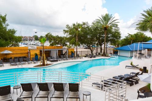 a swimming pool with lounge chairs and a marina at South Shore Harbour Resort and Conference Center in League City