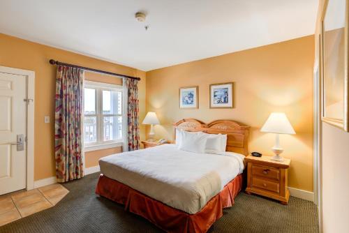 a bedroom with a large bed and a window at Turtle Cay Resort in Virginia Beach