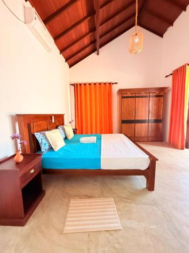 a large bedroom with a bed and a dresser at Ma'Moon Beach Villa in Wadduwa