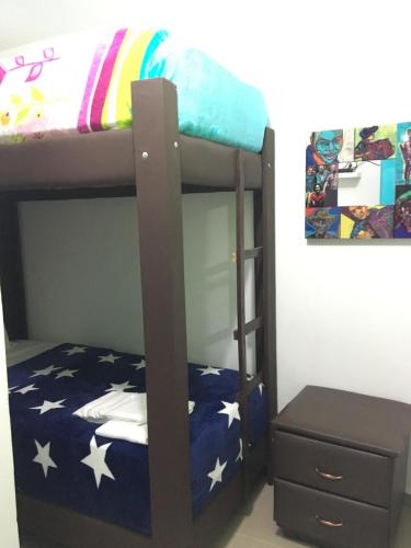 a bunk bed with a ladder next to a dresser at Hostal Johnnier Macao Punta Cana in Punta Cana