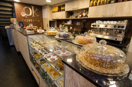 a bakery with a display case filled with pastries at Hotel OK in Rio de Janeiro