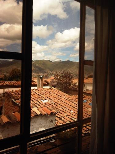 a view of a tile roof from a window at Casa De Mama Cusco - The Treehouse in Cusco