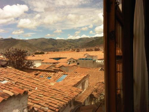 a view of the roofs of a town from a window at Casa De Mama Cusco - The Treehouse in Cusco