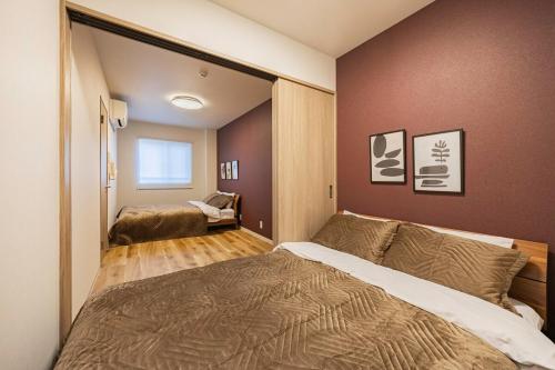 a bedroom with a large bed in a room at Lino Stay Kasai 'elua in Tokyo