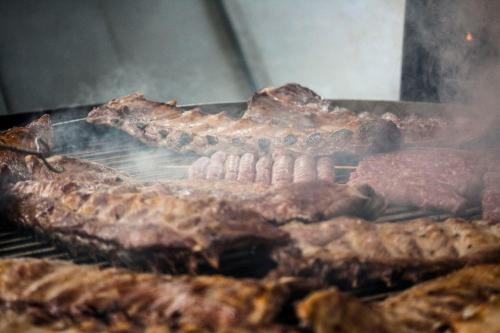 a bunch of meat cooking on a grill at Agriturismo Villa Mocenigo in Mirano