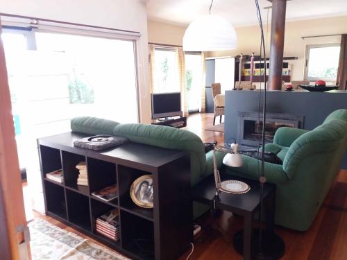 a living room with a couch and a chair at Casa da Fonte Trigueira in Mondim de Basto