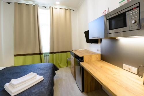 a small room with a desk and a microwave at Partner Guest House Khreschatyk in Kyiv