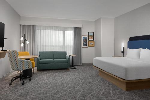 a hotel room with a bed and a desk and a chair at Hampton Inn By Hilton Dexter in Dexter