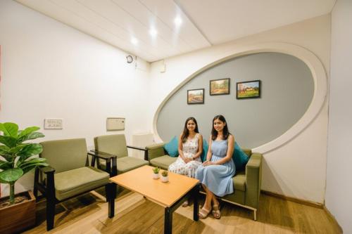 two women sitting in a waiting room at FabHotel Dev Palace I - Pitampura in New Delhi