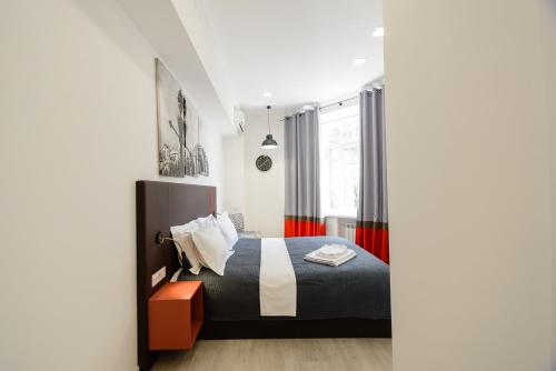 a bedroom with a bed and a window at Partner Guest House Khreschatyk in Kyiv