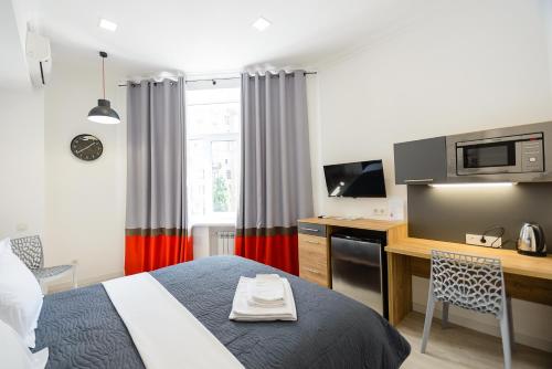 a bedroom with a bed and a desk with a computer at Partner Guest House Khreschatyk in Kyiv