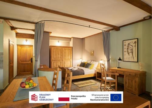 a bedroom with a bed and a table and a dining room at Vincent OldTown Apartments in Wrocław