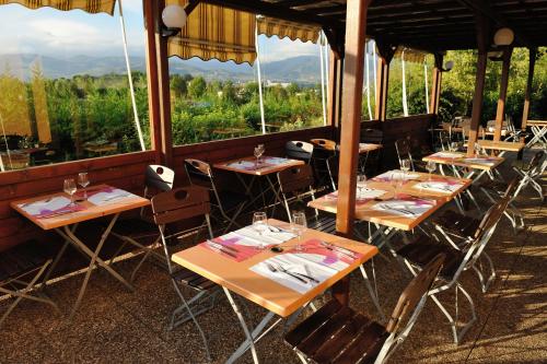 a row of tables in a restaurant with a view at Campanile Saint-Etienne Est- Saint-Chamond in Saint-Chamond